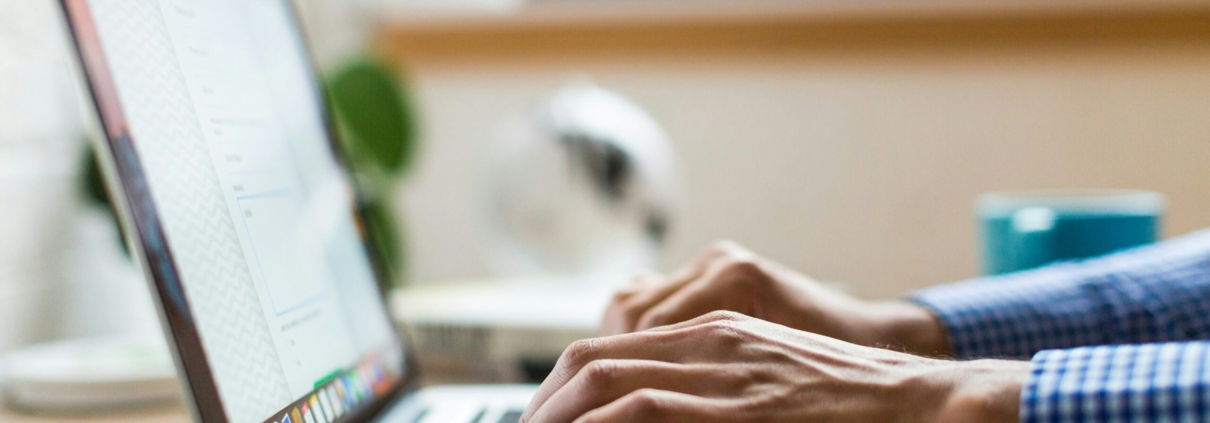 person typing on silver Macbook