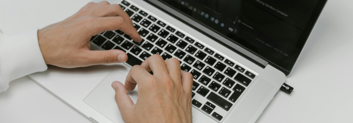 Free Hands on a Laptop Keyboard Stock Photo