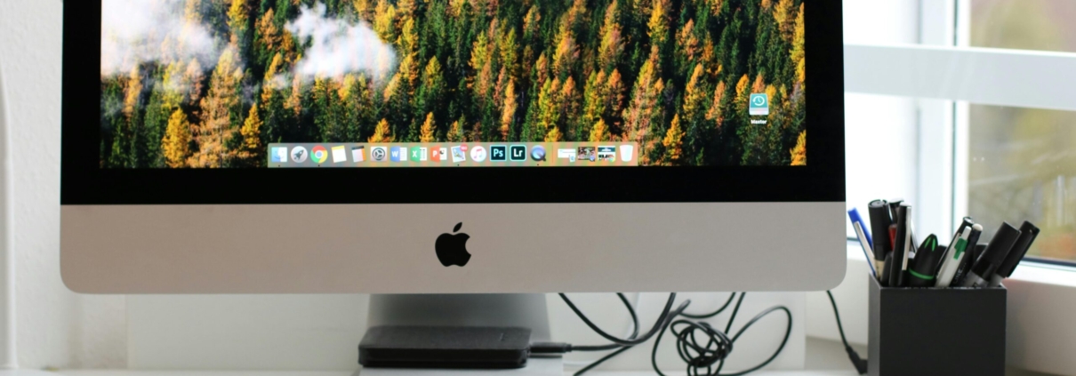Free Stylish home office workspace featuring a computer setup with accessories. Stock Photo