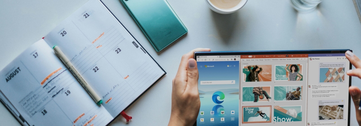 person using Windows 11 computer beside white ceramic mug on white table