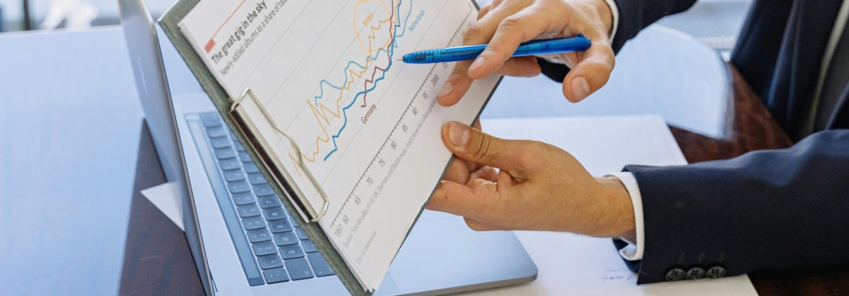 Free Business professionals discussing financial graphs and charts in an office setting. Stock Photo