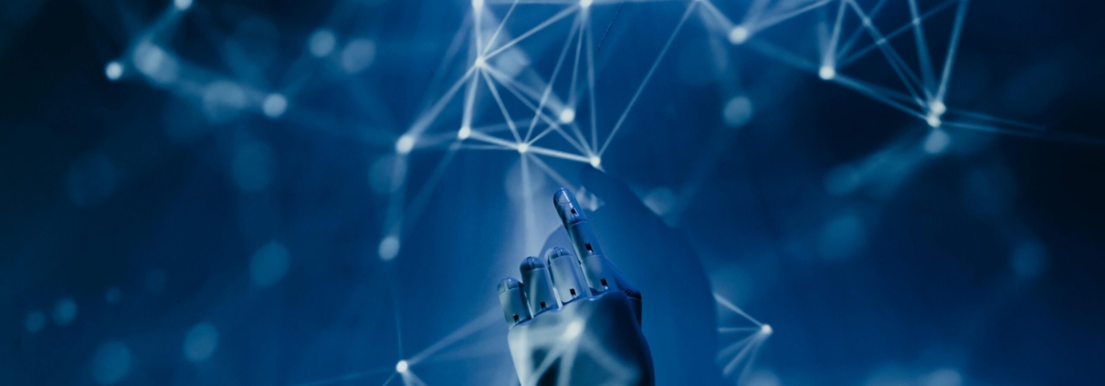 Free A robotic hand reaching into a digital network on a blue background, symbolizing AI technology. Stock Photo